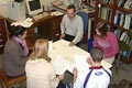 students discuss an essay with their tutor